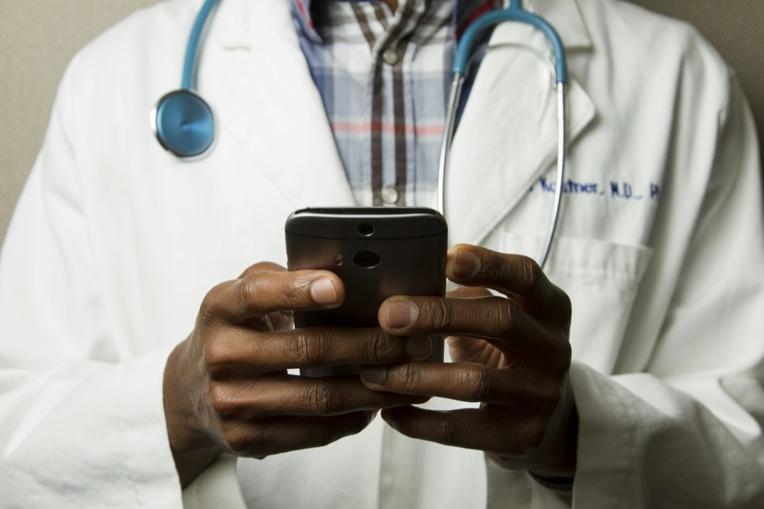 Physician reviewing recommendations on a phone